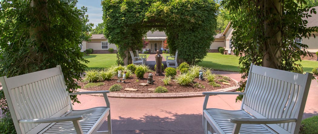 Seating area in a lush garden at the facility