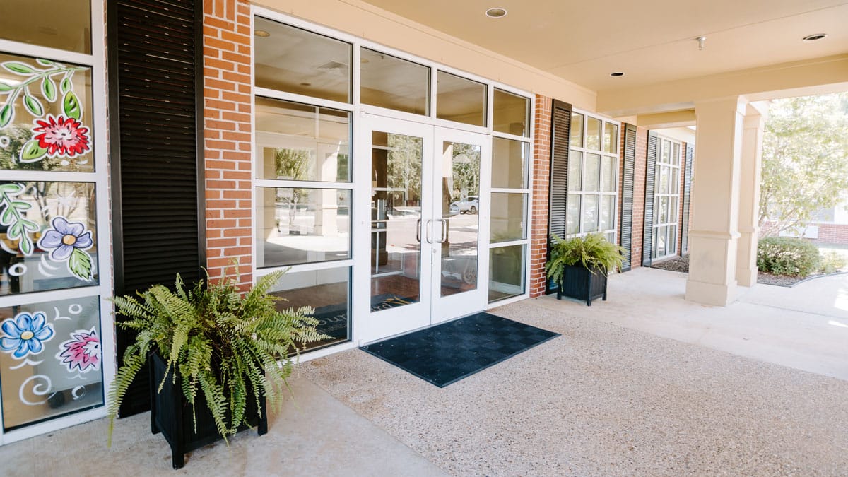 Entrance of a senior living facility with planters