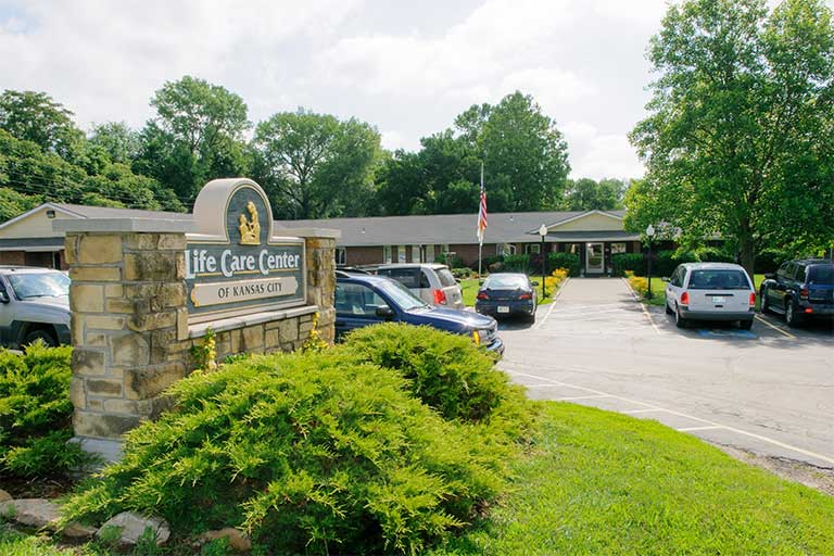 Life Care Center, Nursing Home in Fitzgerald, GA — Entrance sign of Life Care Center with landscaped parking area