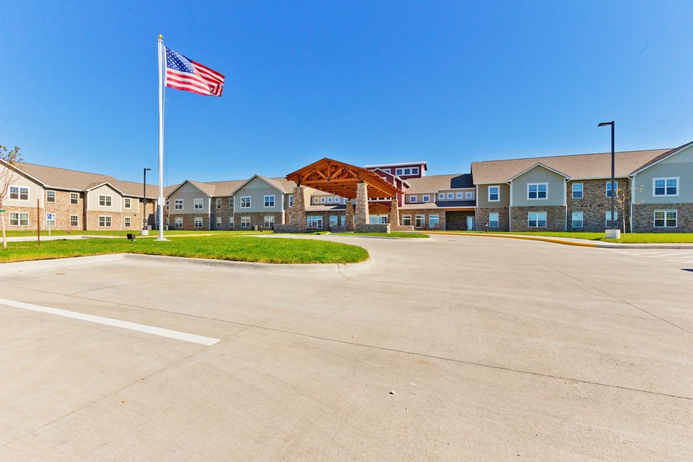 Exterior view of a senior living facility with flag