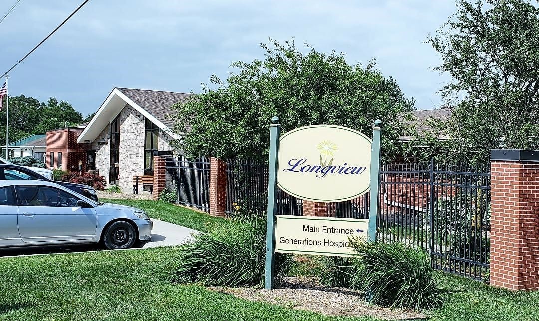 Building exterior with entrance sign in front yard