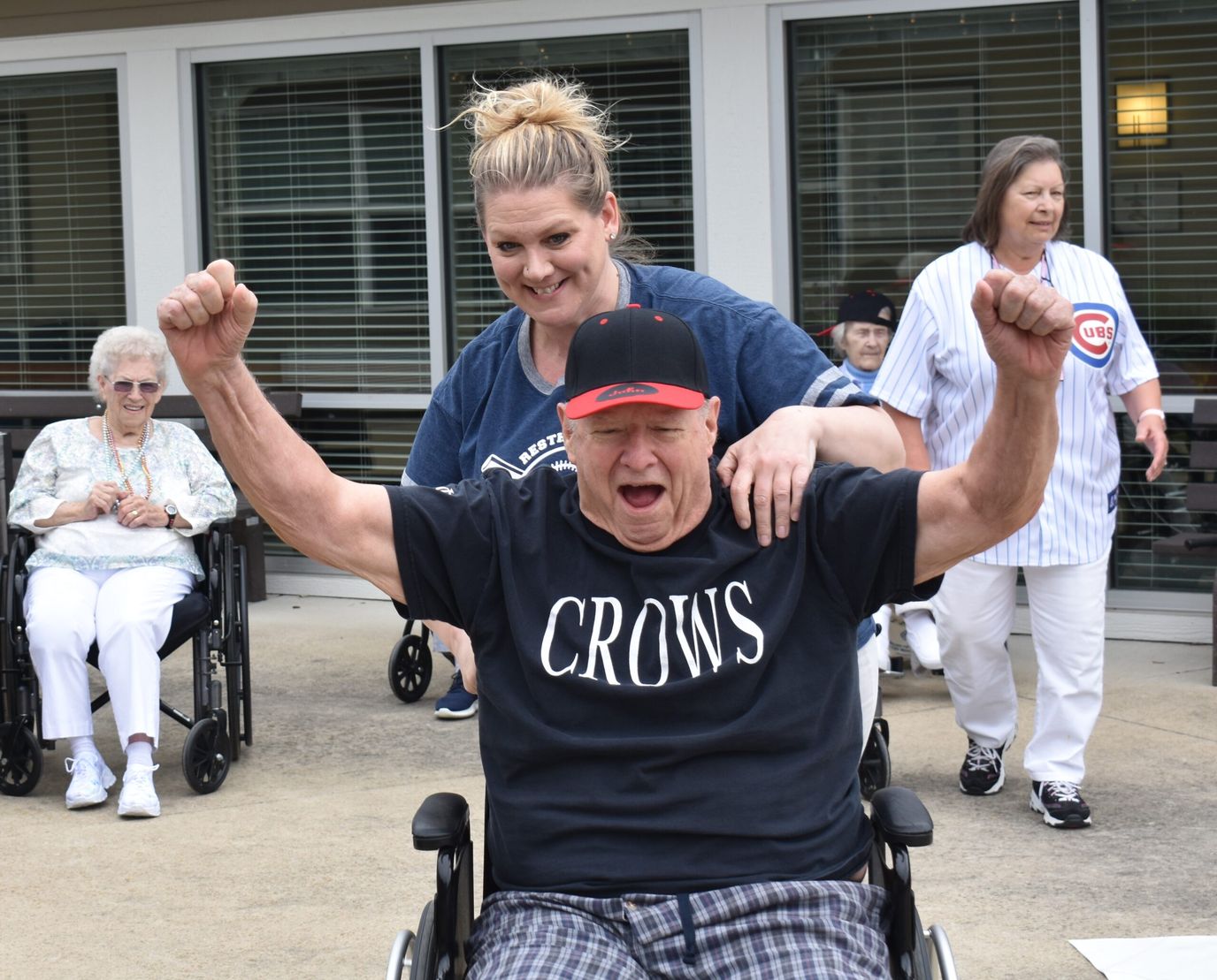 Residents enjoying outdoor activities in wheelchairs
