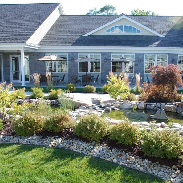 Exterior view of a senior living facility with landscaped gardens