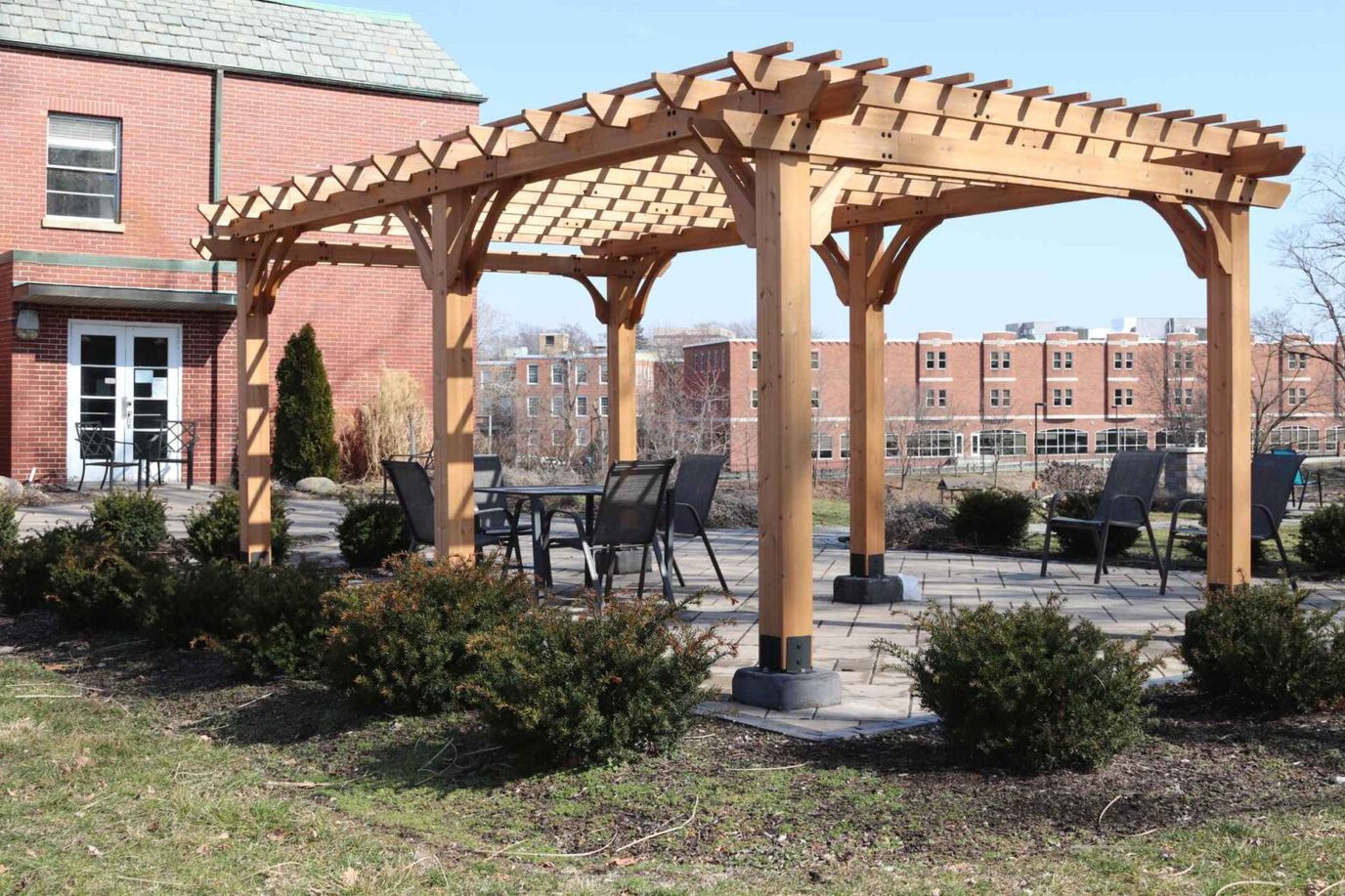 Outdoor pergola with seating area and landscaping