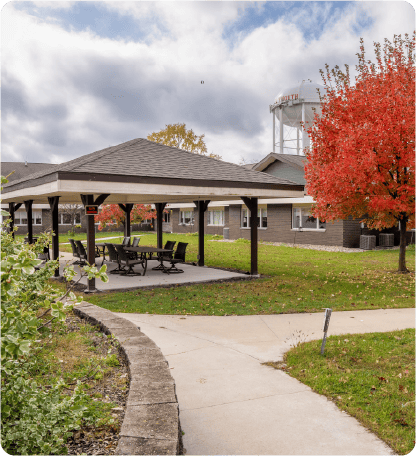 Outdoor gazebo area with colorful autumn trees
