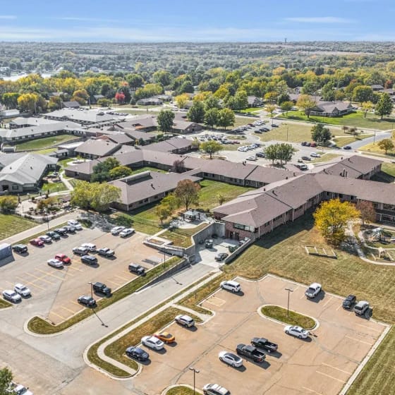 Aerial view of a senior living facility with landscaped grounds