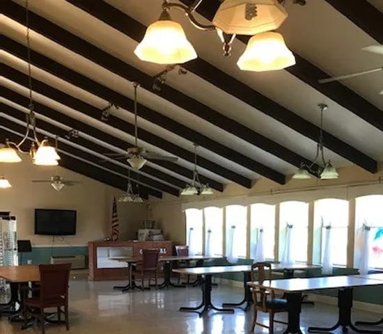 Bright common area with high ceilings and tables