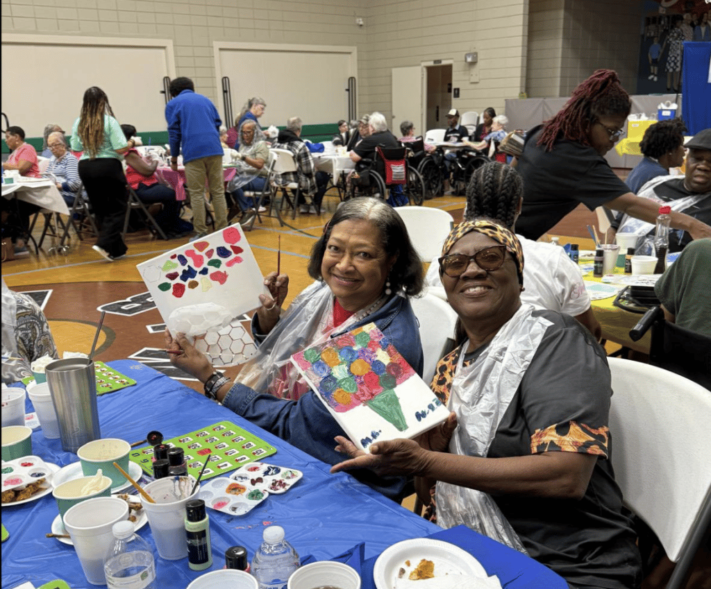 Residents engaged in a creative activity at a communal table