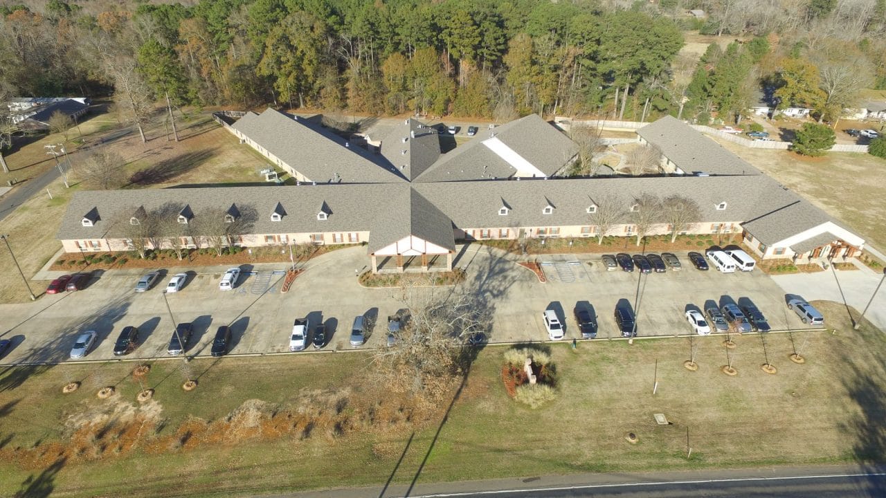 Aerial view of a senior living facility with parking