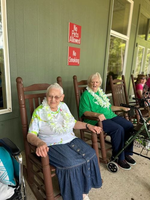 Princeton Place-Ruston, Nursing Home in Ruston, LA — Two elderly women in rocking chairs with leis