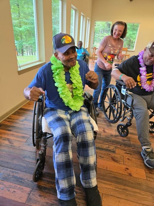 Princeton Place-Ruston, Nursing Home in Ruston, LA — Residents in wheelchairs celebrating with leis and smiling
