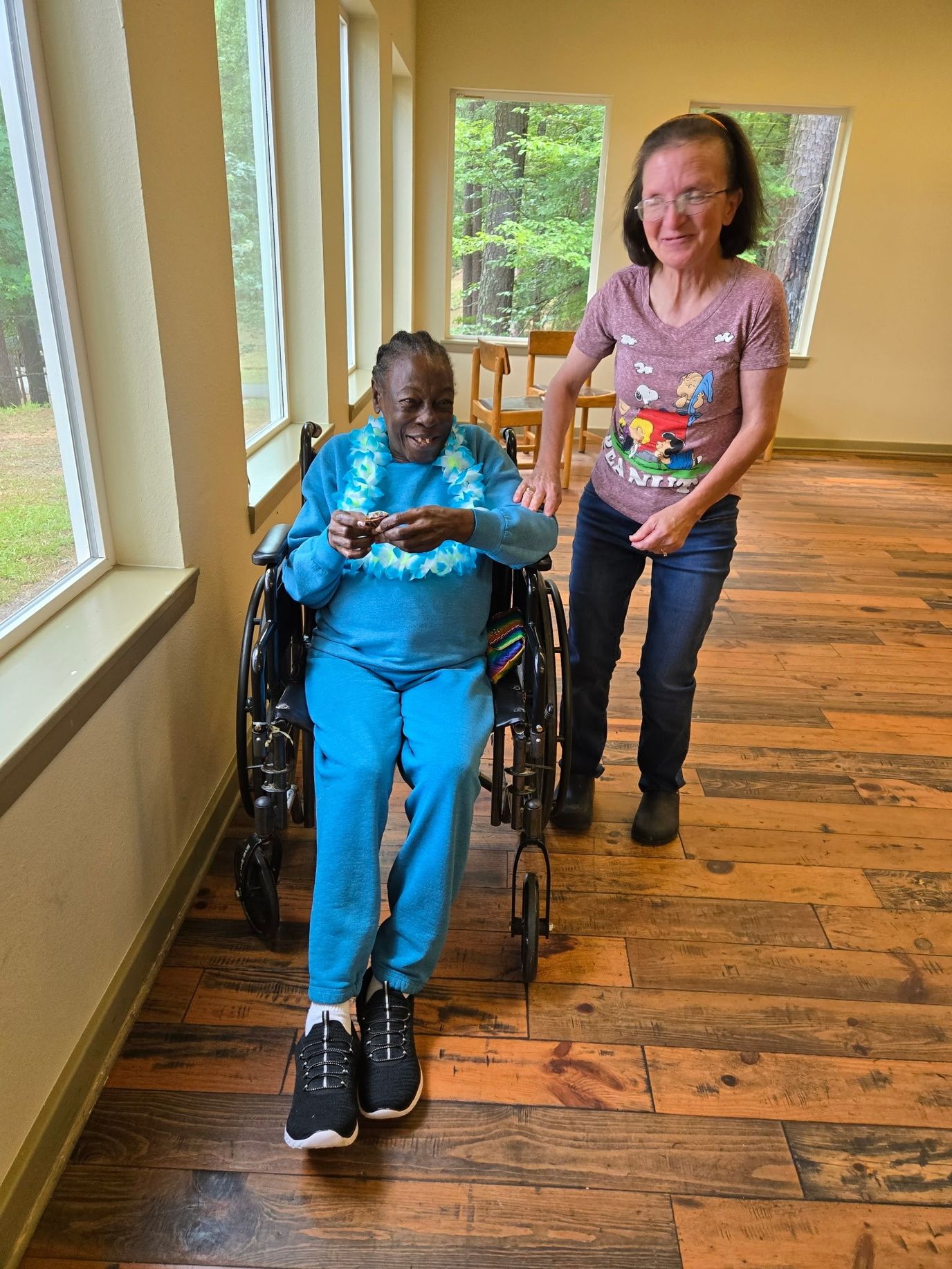 A resident and staff member interacting in a common area
