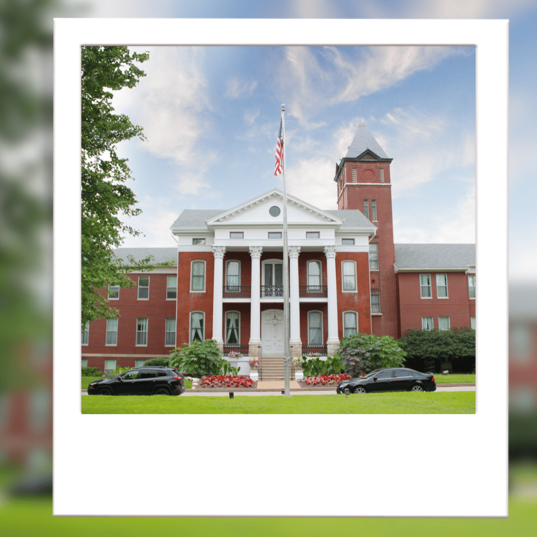 Historic nursing home building with landscaped entrance
