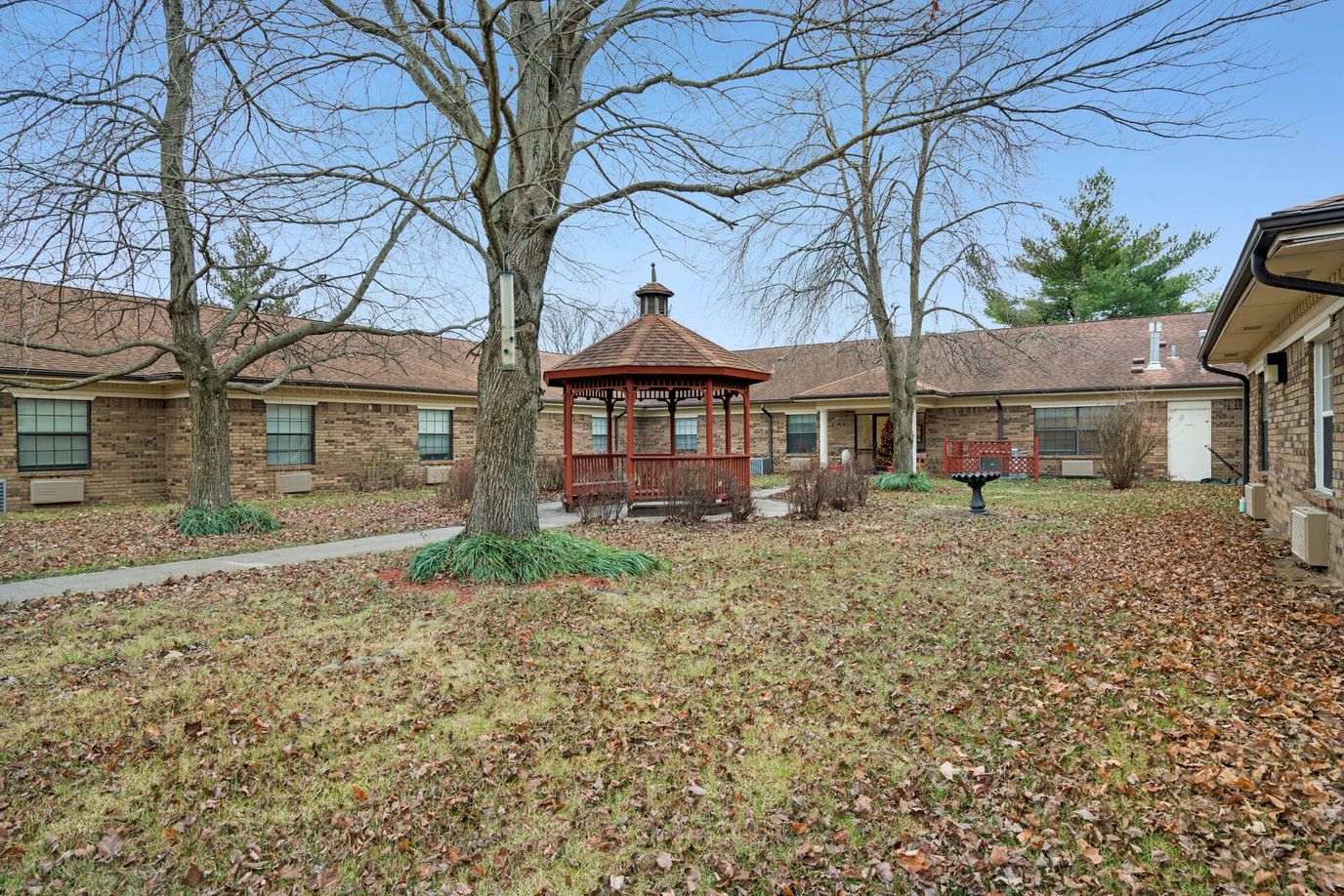 Outdoor courtyard with a gazebo and trees
