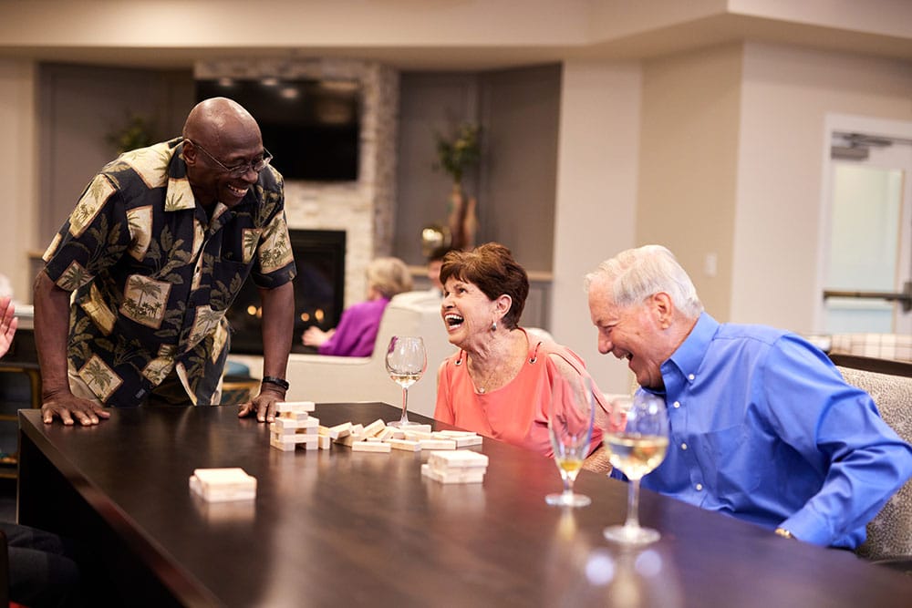 Residents enjoying a lively game night in a common area