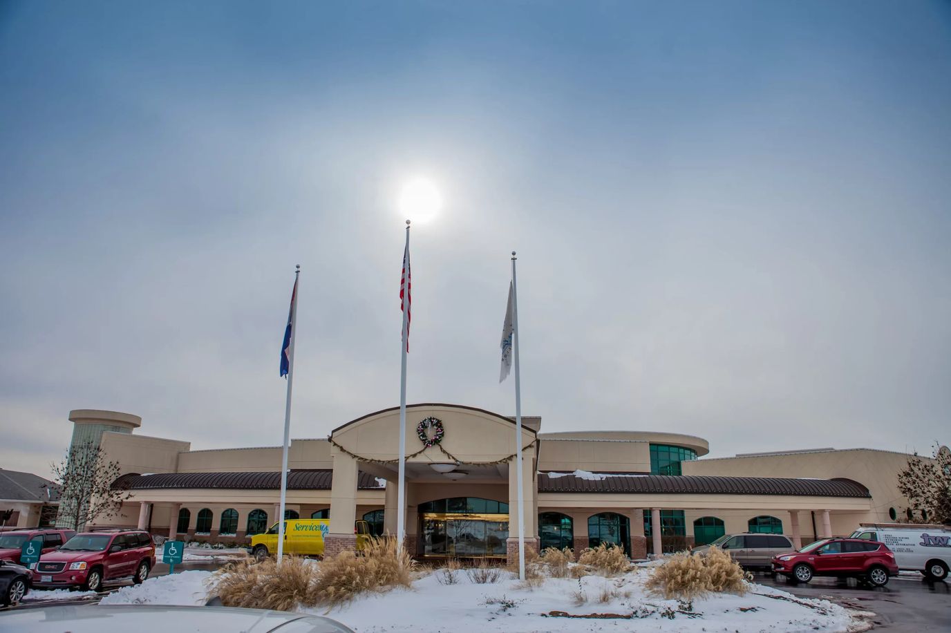 Exterior view of assisted living facility with flags