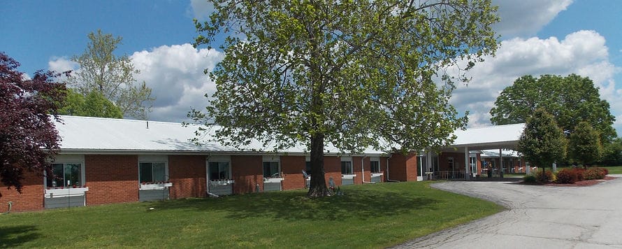 Exterior view of the assisted living facility with trees