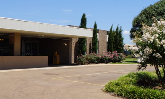 Exterior view of a senior living facility with landscaping