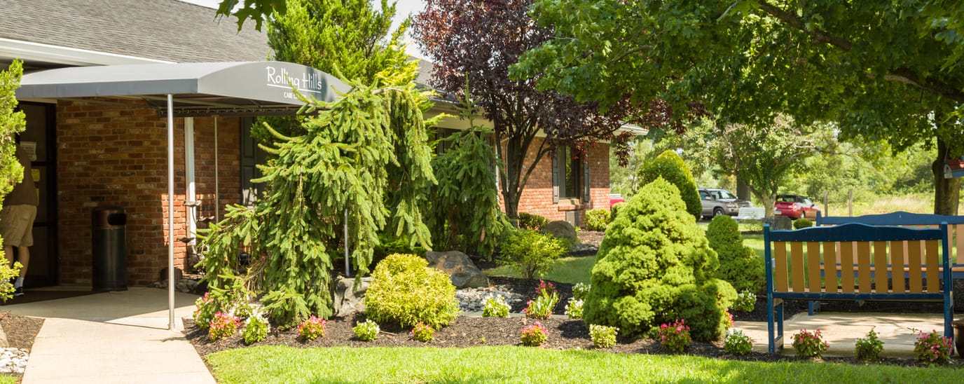 Lush gardens and seating area in front of facility