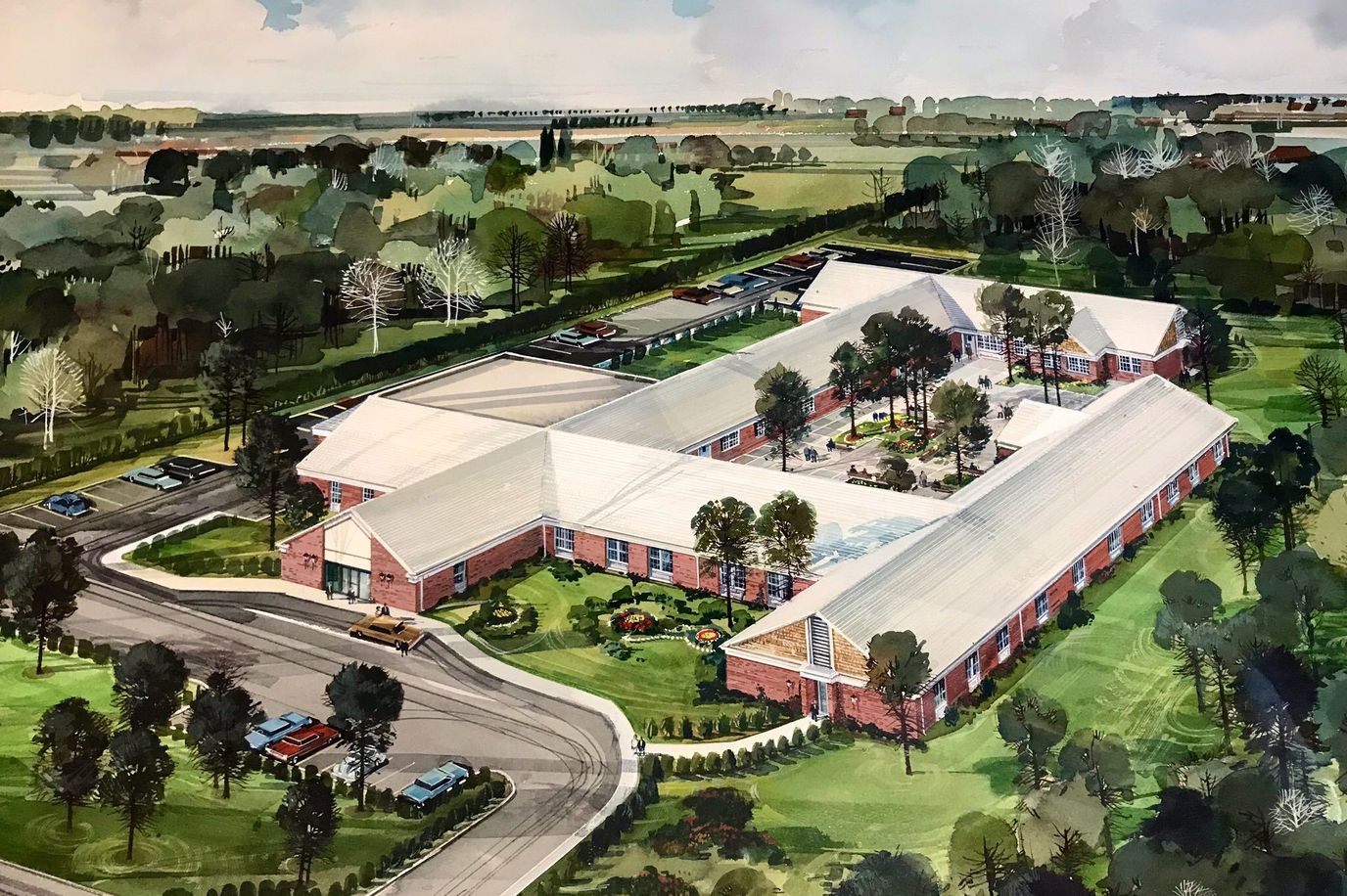 Aerial view of a senior living facility surrounded by greenery