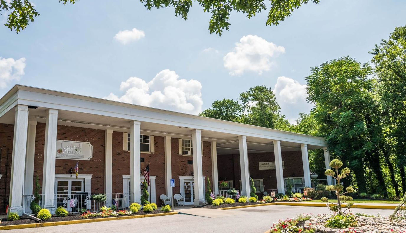 Exterior view of a senior living facility with gardens