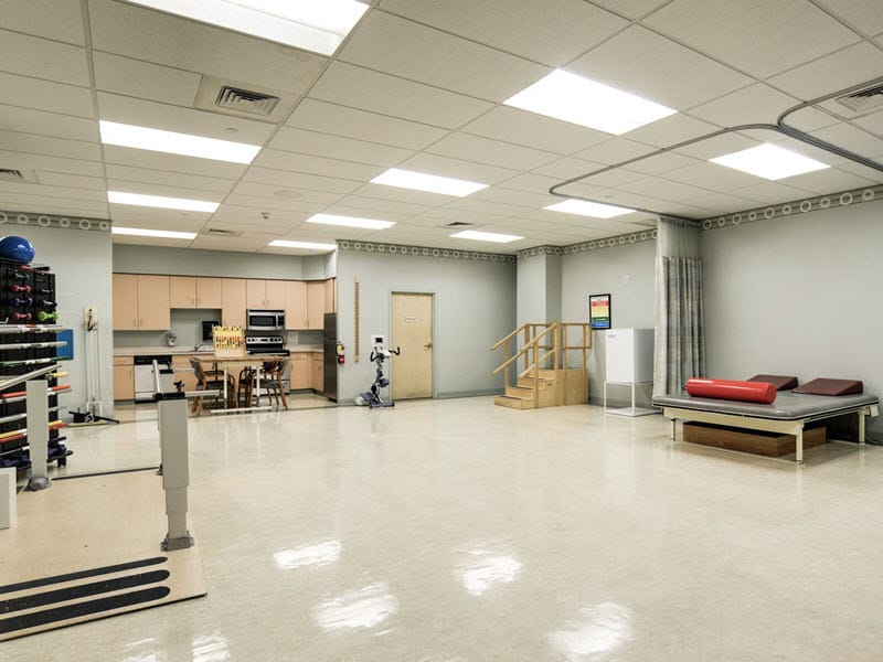 Spacious rehabilitation therapy room with equipment
