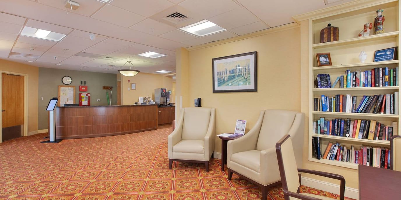 Interior view of a lobby area with seating and bookshelf