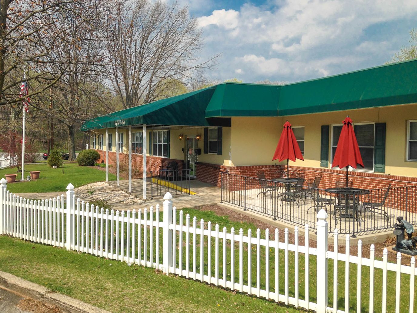Exterior view of a senior living facility with outdoor seating