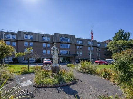 Exterior view of a senior living facility with grounds