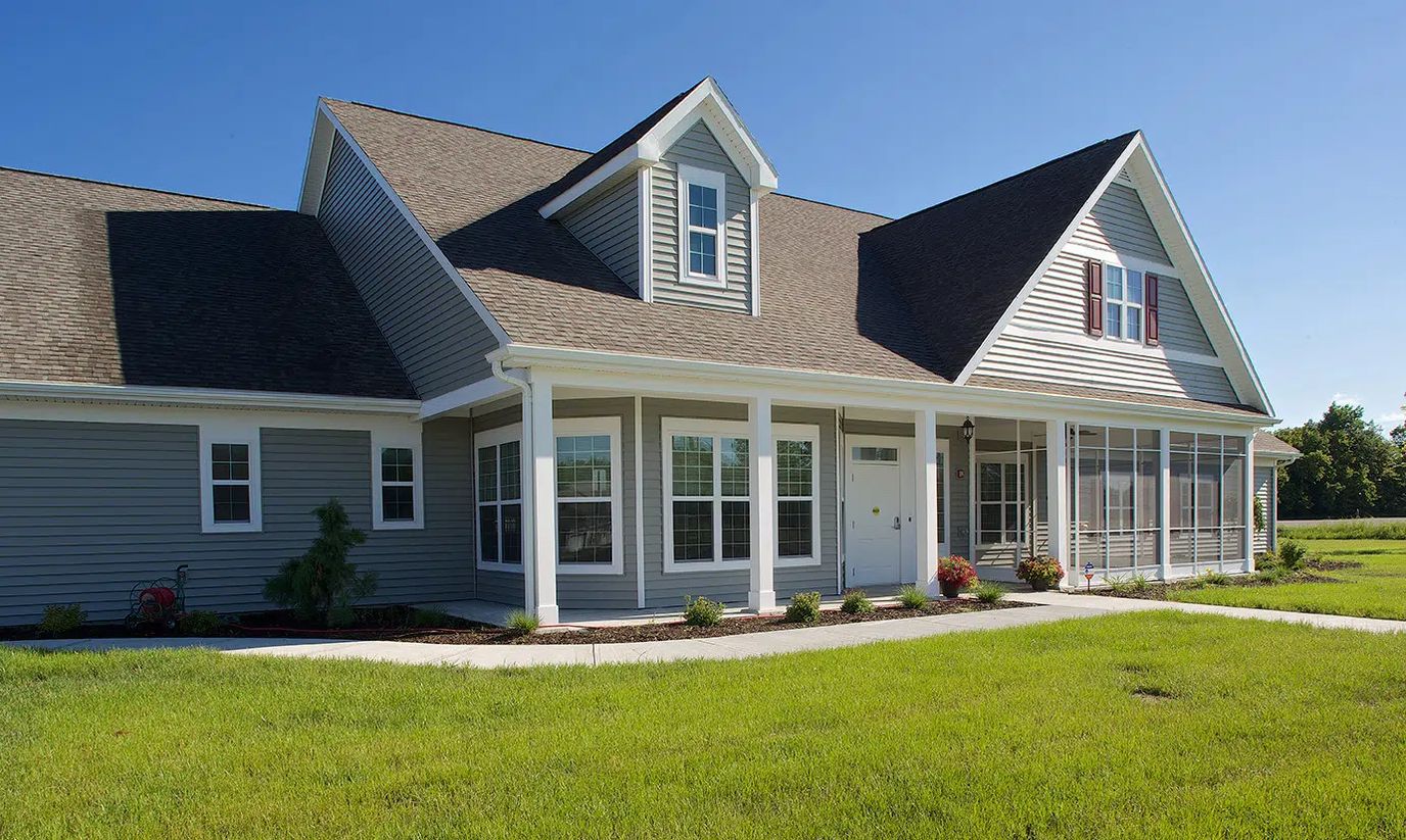 Exterior view of a senior living facility with landscaped lawn