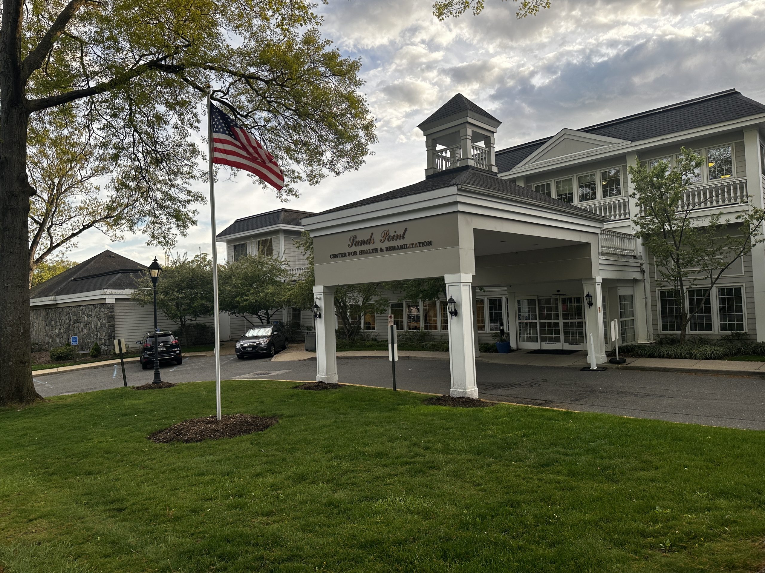 Entrance of the assisted living facility with American flag