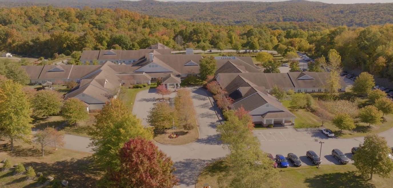 Aerial view of the senior living facility surrounded by fall foliage