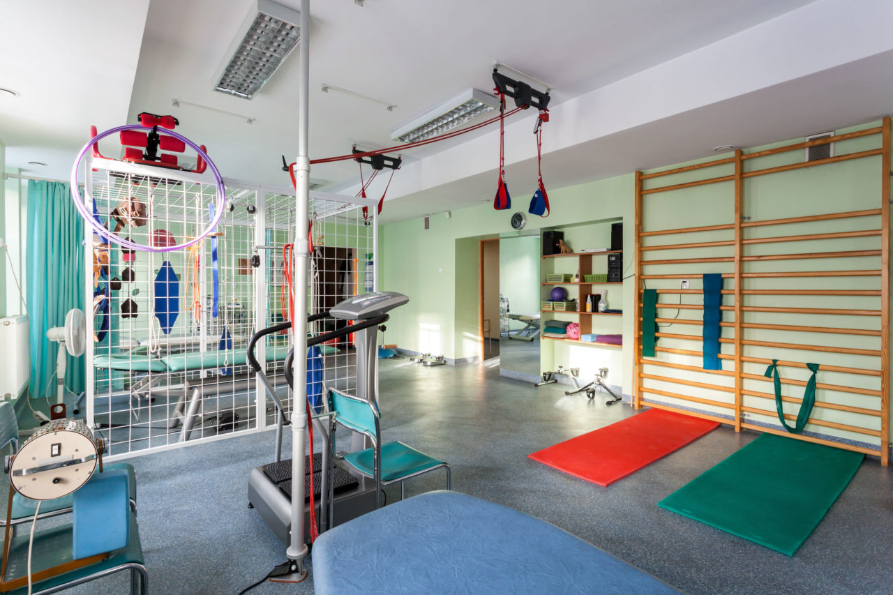 Well-equipped physical therapy room with exercise equipment