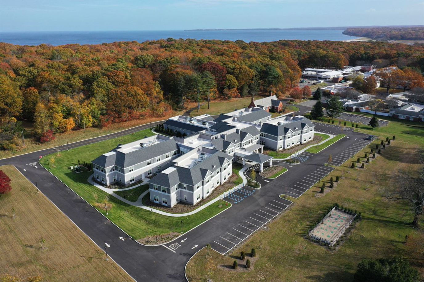 Aerial view of a senior living facility surrounded by trees
