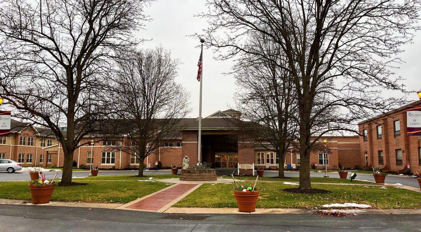 Front entrance of a senior living facility with gardens