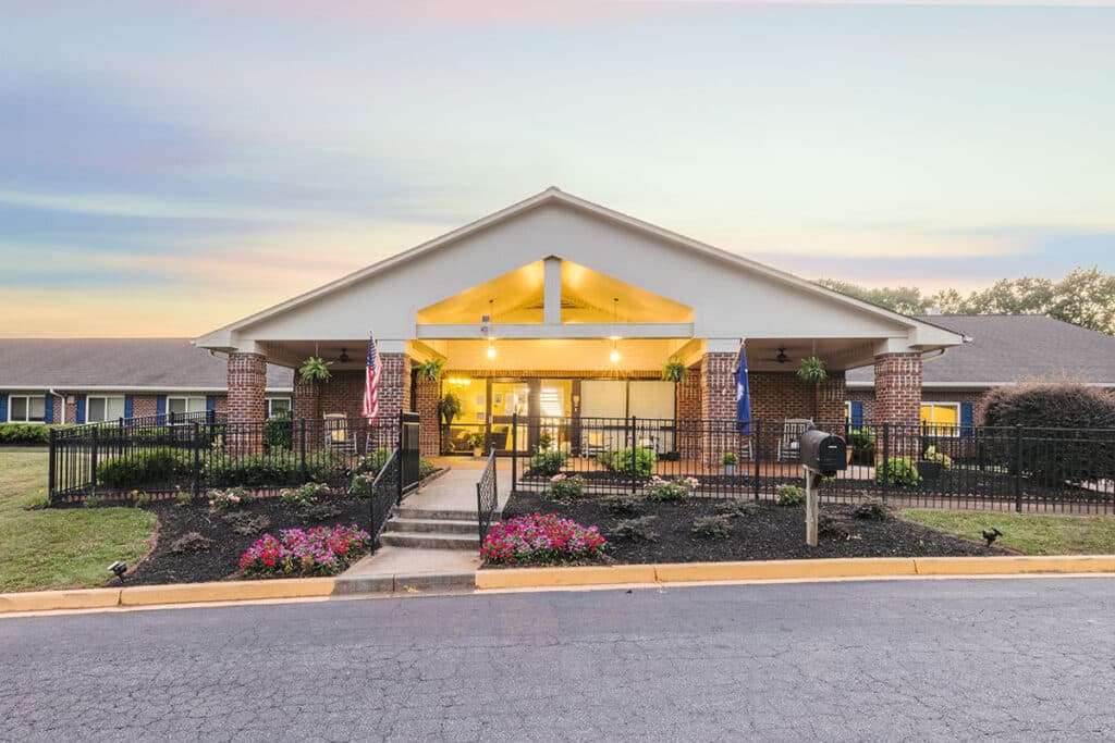 Front entrance of a senior living facility with gardens