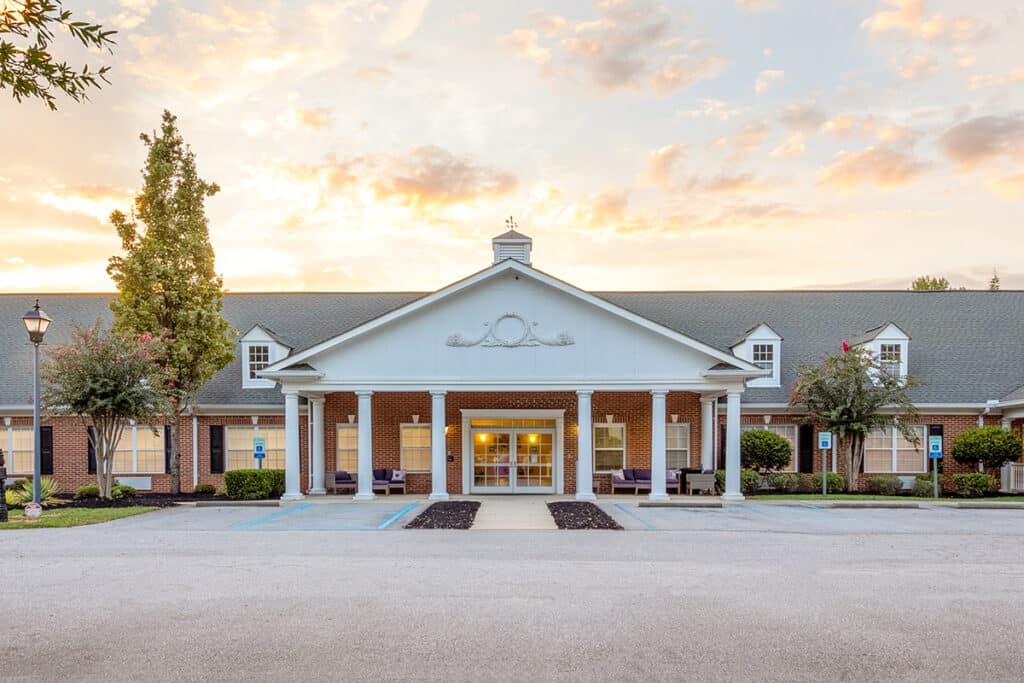 Exterior view of a senior living facility during sunset