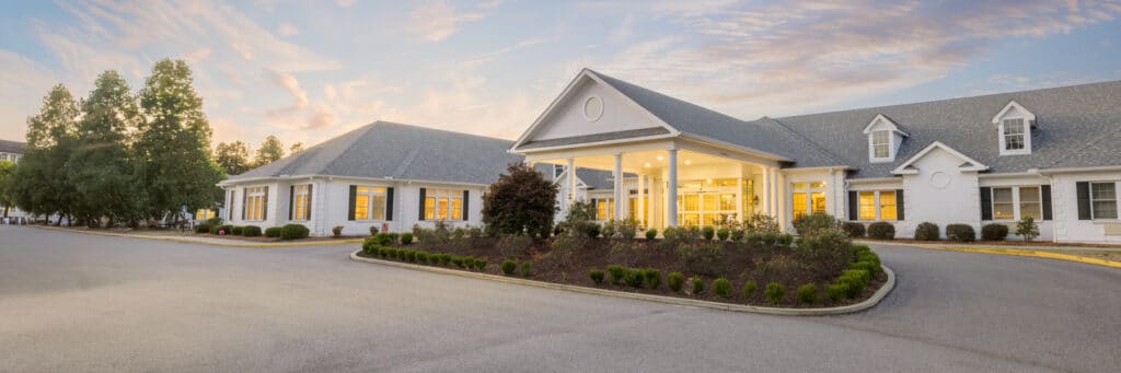 Exterior view of a senior living facility surrounded by landscaping