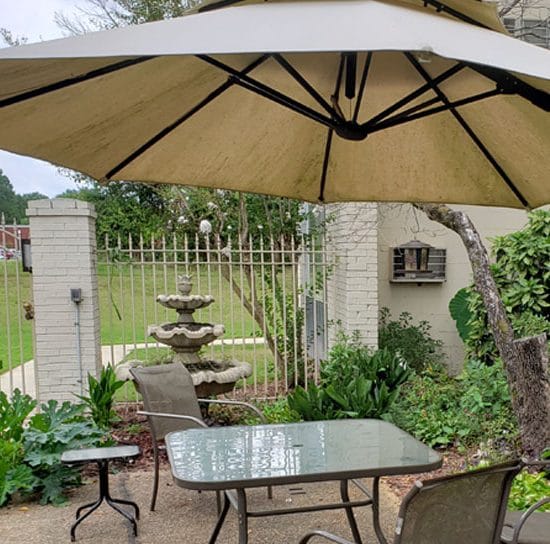 Outdoor seating area with patio umbrella and fountain