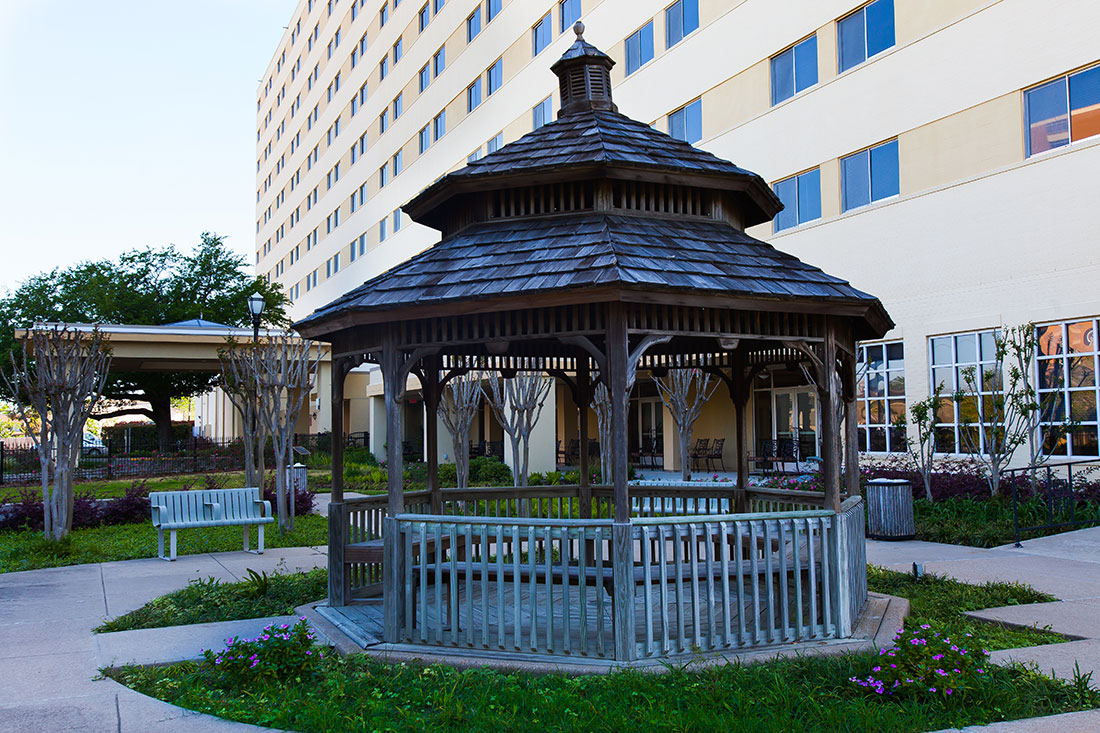 Gazebo surrounded by landscaped garden in a senior living facility