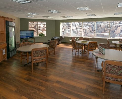 Bright common area with large windows and seating