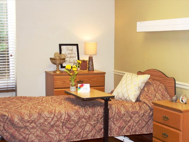 Cozy resident room with a bed and flowers