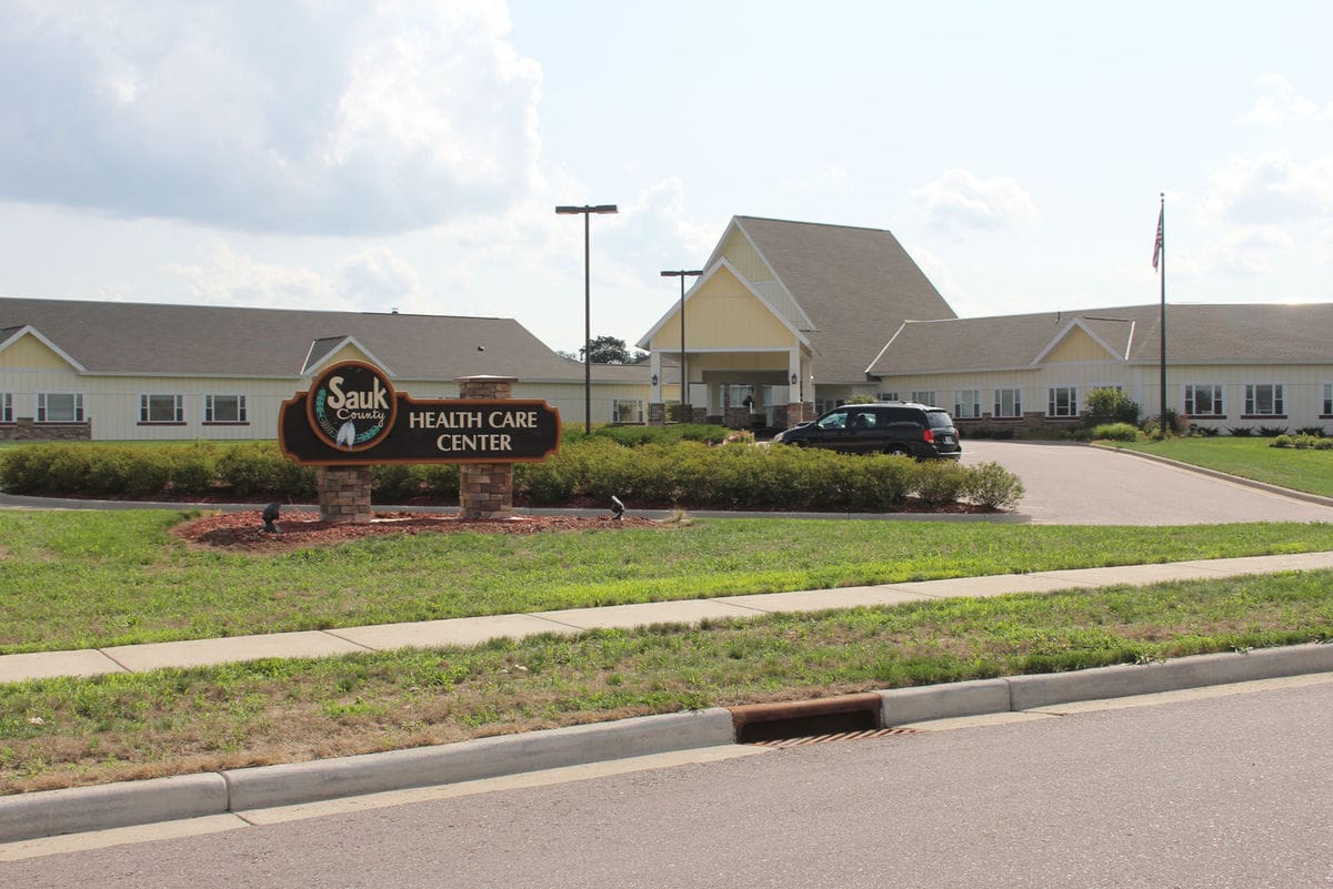 Sauk County Health Care Center, Nursing Home in Reedsburg, WI — Sauk County Health Care Center entrance with signage and landscaping