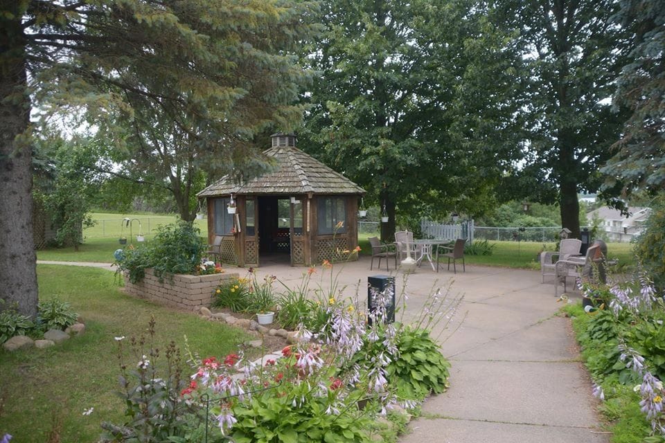Shell Lake Health Care Center, Nursing Home in Shell Lake, WI — Gazebo in a landscaped garden surrounded by trees