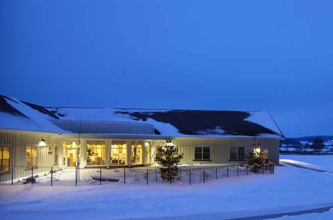 Sauk County Health Care Center, Nursing Home in Reedsburg, WI — Snow-covered senior living facility at dusk with lights