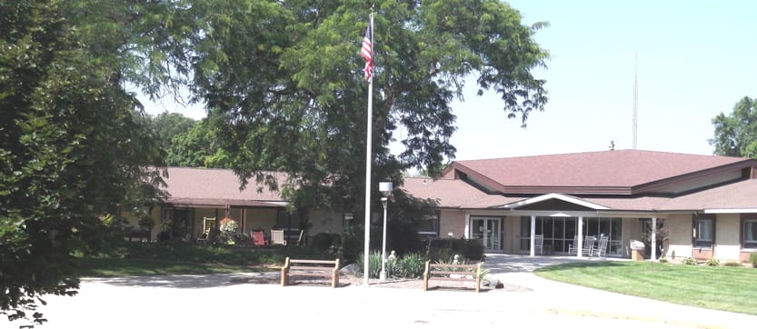 Exterior view of a nursing home facility with landscaping
