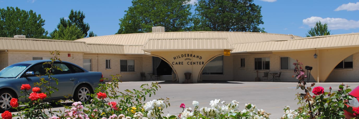 Exterior view of Hildebrand Care Center with flowers
