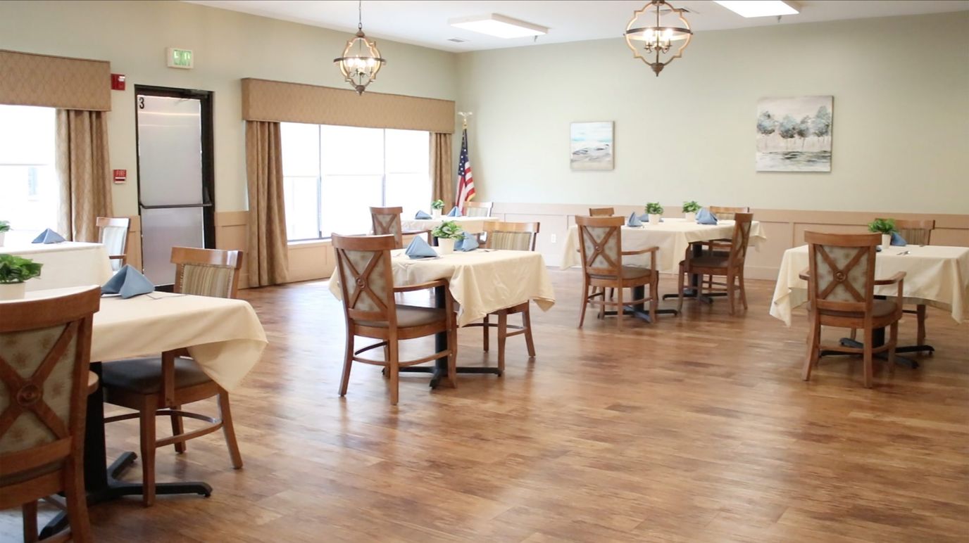 Dining area set up for meals with tables and chairs