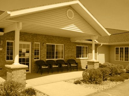 Entrance of a senior living facility with seating