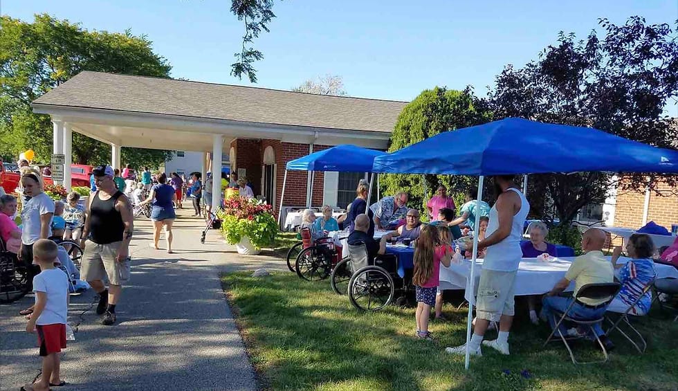 Residents and families enjoy a community gathering outside